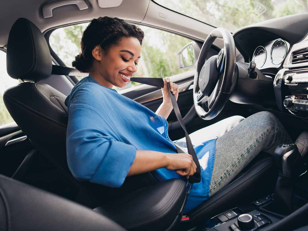 Teenage girl buckling up in car driver's seat learning to drive at Macomb County's Best Driving School Great Lakes Academy Driving School in Romeo, Michigan